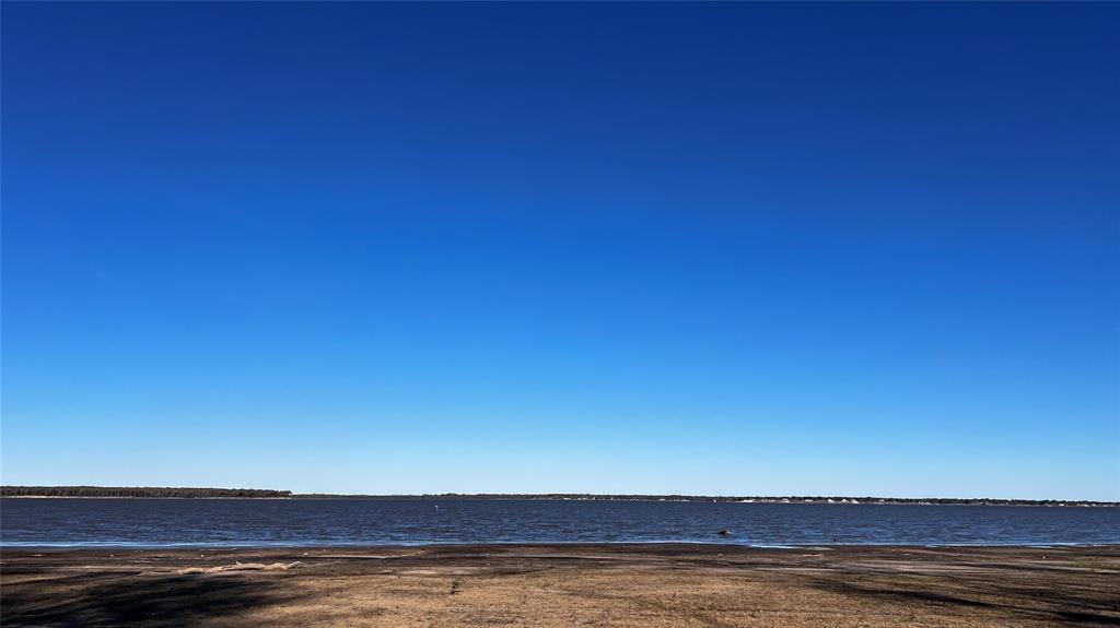 Discover the Perfect canvas for your dream home on this exceptional 1.25-acre Waterfront lot on Cedar Creek Lake. With an impressive 241 feet of waterfrontage, this property offers expansive lake views and private water access, creating an ideal setting for luxury lakeside living. Nested among mature trees in the prestigious gated community of Edgewater, you'll enjoy serenity, security, and a neighborhood of upscale homes. Community amenities include underground utilities, paved roads, a lakeside pavilion, and boat slips, ensuring comfort and convenience from day one. Located just one hour from the Dallas Metro area, this property delivers the perfect balance of peaceful retreat and accessibility. Whether building a weekend getaway or a full-time residence, this stunning lot provides the space, views, and lifestyle you've been searing for on Cedar Creek Lake.