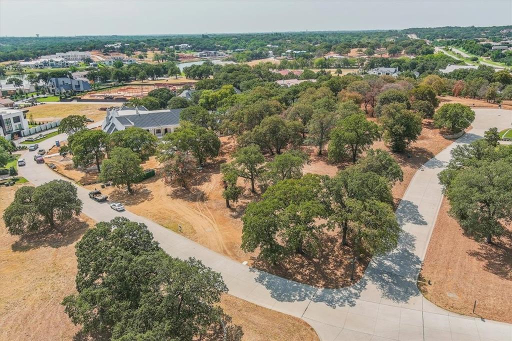 Quail Hollow has a feel unlike any other neighborhood in North Texas.  The Estates of Quail Hollow feature a collection of grand modern estates in an exclusive 24 hour guard gated community.  School options include your choice of the Westlake Academy, Keller ISD, or open enrollment to Southlake CISD.  The gentle slope, mature trees and entry options provide endless possibilities to build your paradise on this 1+ acre lot.  With limited opportunities to acquire estate lots in this premier development, now is the time to secure your future of unparalleled luxury living.  Listing Broker is related to Seller.