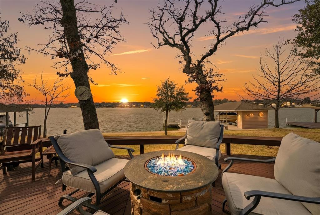 Looking for a standout lake property? This Blackfoot peninsula home delivers big water views, generous space, and a layout built for hosting. Tucked near the end of one of Lake Kiowa’s most desirable streets, the setting offers privacy and incredible scenery.

The entry opens to a spacious living area with a wall of windows overlooking the lake, gas fireplace, and multiple seating options. The adjoining dining room flows into an oversized kitchen featuring double ovens, built-in refrigerator, wine fridge, ice maker, prep sink, and extensive cabinetry and counter space—ideal for entertaining.

The main-level primary suite is a true retreat with lake views, gas fireplace, built-ins, room for a sitting area, and a large ensuite bath with jetted tub, dual vanities with seated makeup space, and an expansive walk-in closet with built-in dressers and cedar closet. The closet connects directly to the laundry room for convenience.

A second primary suite downstairs is perfect for guests. Upstairs you’ll find three additional oversized bedrooms, all with walk-in closets. One has a private bath, while the other two share a full bath with easy access to the upstairs living area or game room.

Storage and hobby space are exceptional with an oversized three-car garage with half bath, plus a separate 17' x 21' golf cart garage and workshop.

Outdoor living is just as impressive. A covered front porch connects to a wraparound deck leading to the back patio with fire pit, hot tub, and surround sound, and a path to the updated dock. The dock features Trex decking, boat lift, manual jet ski lift, storage closet, and a gazebo for shaded seating and lake views.

Lake Kiowa is a gated lake and golf community featuring a private lake, an acclaimed 18-hole course and 9-hole par three course with unlimited golf for property owners, and resort-style amenities including beaches, parks, a restaurant, pro shop, and round-the-clock security.