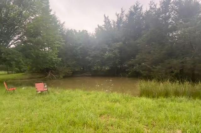 Situated on 1.8 acres, this unique property features a picturesque pond that has provided years of enjoyment, including fishing and small boat use. Enjoy the tranquility of country living while being just 15 minutes from Lake Tawakoni. With its serene setting and natural beauty, the land offers endless potential for a new build or investment opportunity. the existing structure will require extensive renovation or removal and is being sold AS IS.