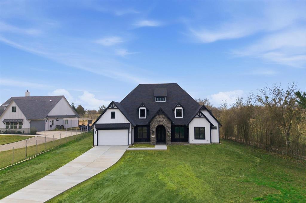 Experience refined country living in this stunning custom-built home, thoughtfully designed with both luxury and flexibility in mind. This four bedroom residence offers soaring 12+ foot ceilings and an open, light filled layout ideal for everyday living and entertaining. Each spacious bedroom features its own private full bathroom, providing comfort and privacy for family and guests alike. The primary suite is a true retreat, complete with a generous walk-in closet and custom built-in drawers for effortless organization. A dedicated office adds functionality for remote work or study. At the heart of the home, the chef’s kitchen impresses with a gas cooktop that can easily be converted to electric, a massive butler’s pantry, and a convenient coffee nook perfect for morning routines or hosting. The living area showcases an electric fireplace that can also be converted to gas, blending modern style with adaptable design. Step outside to enjoy country living at its finest with a built in outdoor grill, ideal for gatherings and entertaining year round.This custom residence is finished with a well-appointed garage featuring an electric vehicle charging station, underscoring its modern design and attention to detail. Come and make memories in your forever home!
