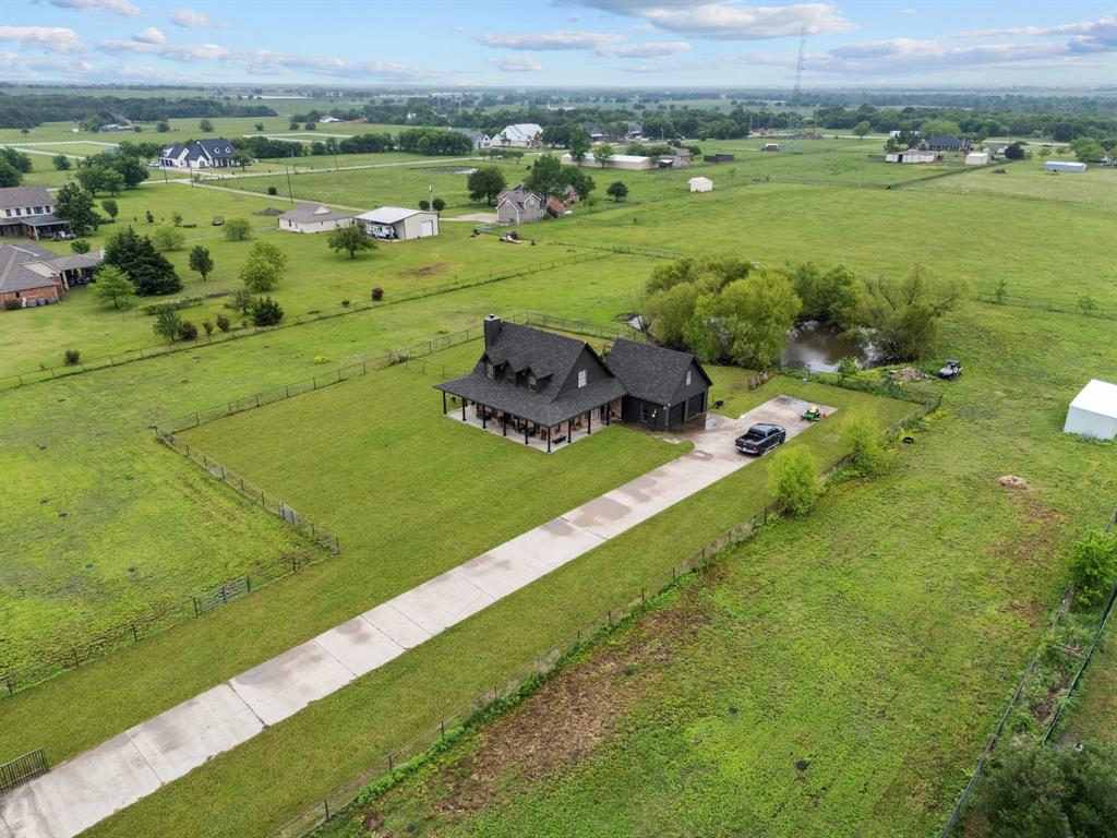 Looking for country living with the convenience of big city amenities? Welcome home to this beautiful ranch-style home in Rockwall-Heath’s award-winning school district. Situated on just under 3 acres, this one-of-a-kind property offers plenty of space for horses, goats, chickens, or even cows—and includes a barn ready for your animals or hobbies.

This thoughtfully designed floor plan features a serene downstairs primary suite with a decorative tray ceiling and a wall of windows, creating a light-filled retreat. The primary bath offers dual sinks, a walk-in closet, walk-in shower, and a relaxing garden tub. The impressive gourmet eat-in kitchen showcases stunning granite countertops and a sweeping island that overlooks the sophisticated dining room and comfortable living room with fireplace and a wall of windows.

Upstairs, you’ll find two additional bedrooms and a spacious game or media room loft—perfect for family movie nights. This room can act as a 4th bedroom.

Recent updates include a new HVAC system, new water heater, fresh exterior paint, and a 3-year-old roof, offering peace of mind for years to come.

Completely move-in ready and waiting for new owners to create lasting memories!