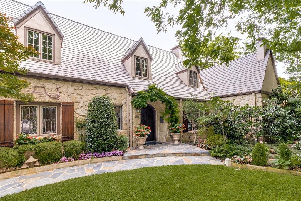 Set across .517 Acres, 3624 Lovers Lane presents a rare expression of English Cotswold architecture, positioned along the storied Culture Gulch pond where art, landscape, and history quietly converge. Inside, repurposed stained glass from historic homes, original glass door knobs, and hand-painted details create a home rich in character and provenance. The formal living room centers around a fireplace and opens to the dining room, where views of the gardens and pond bring a natural sense of calm. A cozy den, equally suited as a study and a billiard room complete with wet bar and doors opening directly to the gardens. The family room forms the heart of the home, anchored by a fireplace and designed for connection, flowing seamlessly into the kitchen and outdoor living areas. The kitchen is expansive and thoughtfully designed, offering generous workspace, a walk-in pantry, and connection to the living spaces. Upstairs, the primary suite offers a private retreat with its own fireplace, a spacious bath with soaking tub and separate shower, and dual closets with abundant storage and windows overlooking the property. Each additional bedroom is appointed with an ensuite bath, ensuring comfort and privacy throughout, while one of these bedrooms offers flexibility as an optional studio, exercise room, or playroom. A beautiful library with built-ins and a pocket bar provides a flexible gathering space, complemented by an upstairs utility room. The outdoor experience is equally considered. The pool and spa are surrounded by stonework, lush landscaping, and multiple seating areas, including a dedicated pool bath. A stone fountain anchors one of several outdoor living spaces, while a fully equipped outdoor kitchen supports effortless entertaining beneath the covered patio with retractable screens. 3624 Lovers Lane is a character-rich estate where architecture, landscape, and cultural legacy exist in quiet harmony.