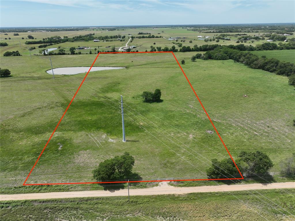 Enjoy 13 acres of open land with a shared pond, scattered trees, county road frontage, and the freedom of being outside the city limits—perfect for your future home or investment plans. Water meter already in place!