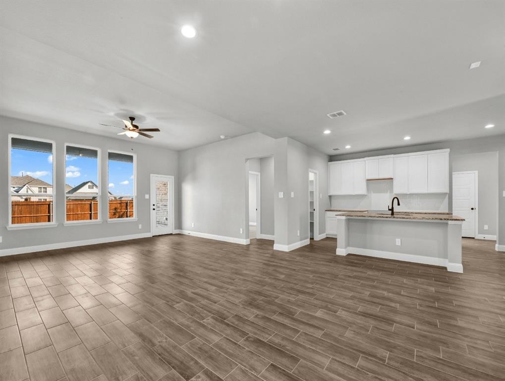 MLS# 21239232 - Built by Taft Homes - Ready Now! ~ This stunning, contemporary residence, slated for completion in July 2026, boasts an impressive 3,017 square feet of living space. Featuring five spacious bedrooms and four full bathrooms, this home is designed for comfort and modern living. The open floorplan highlights decorative lighting, 3cm granite counters, and a kitchen island, perfect for entertaining. Enjoy the convenience of high-speed internet and a smart home system. Dual living areas and a dining space create an inviting atmosphere, while the covered patio offers a serene outdoor retreat. Additional features include vaulted ceilings, walk-in closets, and energy-efficient heating and cooling systems. Nestled in the desirable Summer Crest subdivision within Crowley ISD, this home is a true gem waiting to be personalized. Don't miss this opportunity to own a slice of modern luxury!