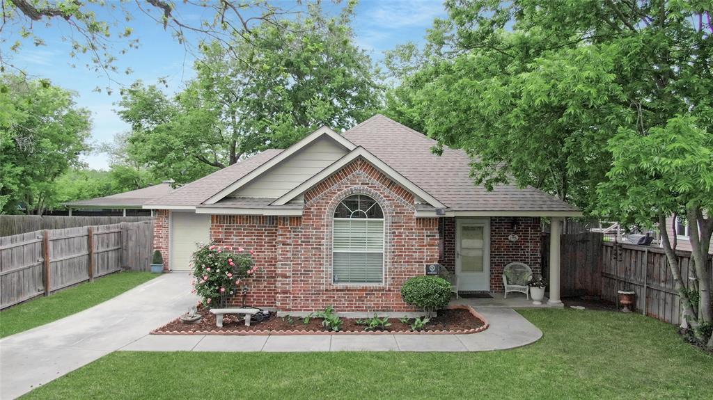 Rare opportunity in the heart of Downtown McKinney! Enjoy the charm, character, and lifestyle of the Historic District with the comfort and confidence of a newer, low-maintenance home. Built in 2008 and beautifully maintained, this move-in ready property offers the perfect alternative for buyers who love Downtown McKinney but prefer modern construction over the upkeep of a century-old home.

Step inside to soaring ceilings, rich hardwood floors, and a bright, open layout highlighted by a stunning arched front window that fills the home with natural light. The inviting living and dining spaces connect seamlessly to a functional kitchen with generous counter space, abundant cabinetry, and excellent flow for everyday living and entertaining.

The private primary retreat features vaulted ceilings, dual vanities, and a spacious walk-in closet, while two additional bedrooms offer flexibility for guests, a home office, or hobbies.

Relax outdoors beneath mature trees and enjoy a peaceful setting with minimal yard maintenance, giving you more time to experience everything Downtown McKinney has to offer. Minutes from award-winning restaurants, boutique shopping, festivals, live music, farmers markets, and year-round community events,  this home delivers the Downtown lifestyle buyers are searching for without sacrificing convenience or comfort.