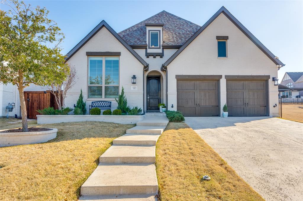 **2.5% ASSUMABLE VA LOAN for VA & Non-VA BUYERS** Like New Meticulously Maintained Beauty with Greenbelt Beside, Behind, and Across! Owners added all-new white oak flooring, shutters, fixtures, and hardware. More than $100K in upgrades abound in this 556H-DX Highland plan. The professional brick landscape encasements welcome you through the spacious entry into the formal study with privacy French doors.  The backyard is designed for both relaxing and entertaining, complete with an outdoor kitchen & covered patio. The guest suite downstairs has an ensuite bath with custom checkered tile and a quartz vanity. The grand living room has 20ft ceilings and a stone fireplace with a raised hearth. Enjoy entertaining in this eat-in kitchen with quartz counters, farm sink, bar stool seating, 6-burner gas stovetop, double oven, walk-in pantry and upgraded lighting, fixtures and hardware. The primary ensuite has vaulted ceilings, wood shutters, a slipper tub, a walk-in shower with rainhead fixture, dual-sink vanity, and quartz counters. Upstairs, find a game room with a window seat, berber carpet, and a dedicated private media room with no windows. Two beds up are large with walk-in closets and have direct access to the full bath with a shower-tub combo and custom tile. Outside, find an extended covered patio with an outdoor kitchen. The 7x11 concrete bar has a built-in Blaze 3-burner griddle and a Traeger grill. Along the side is a professionally installed hardscape gravel and stone path with 30 large stepping stones.  The Walsh community offers 2 pools, tennis, pickleball, a private gym, fishing, maker space, parks, events & more! Seven golf courses within a 10-mile radius! Only 10 minutes from shopping, award-winning BBQ, and only 20 minutes to the Shops at Clearfork! Centrally located between Fort Worth & Weatherford with access to I20 and I30, only 2 miles from the new UTA campus and 12 miles from Top Rated TCU.