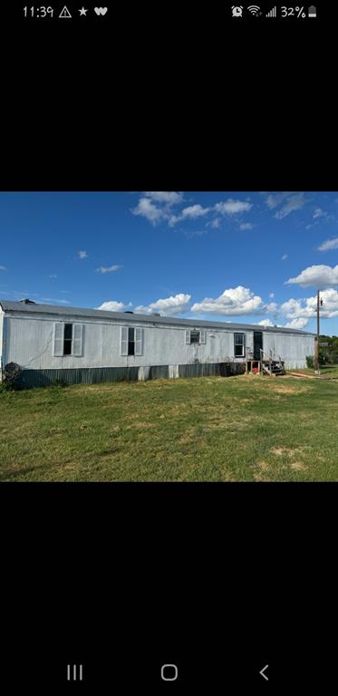 Peace and quiet on slightly over 3 acres. Good location between Brownwood  and  Bangs.  Easy access.  Paved County Road access.  Acreage is level.  Make your personal country retreat or develop the land.
Single wide mobile needs some updates and fresh paint.  It has been a rental property and owners have never lived in it.   Buyers need to inspect and verify condition.  Sold as is condition.