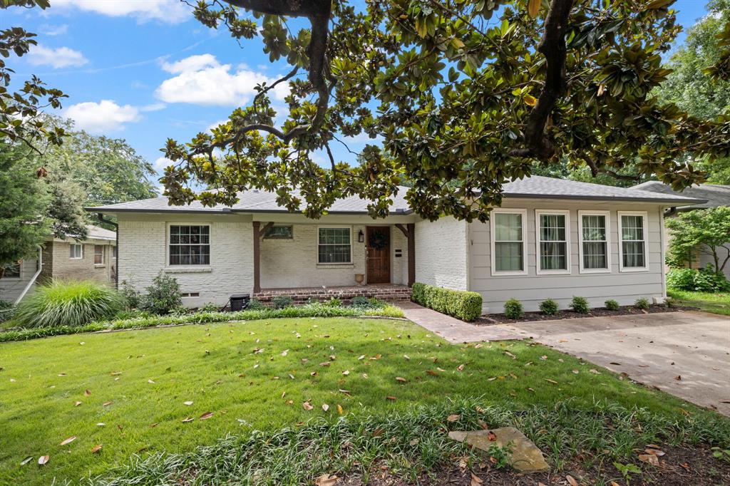 Fabulously updated and move-in ready, this charming 3 bed, 2 bath home sits minutes from White Rock Lake, Ridgewood Park, and Lakewood dining. Curb appeal shines with mature magnolia trees, a covered front porch, and a renovated entry walk custom-paved with specialty brick reclaimed from the historic Fort Worth Stockyards. Inside, an open-concept plan filled with natural light showcases hardwood floors and crown molding, creating easy flow between the living area, dining room, and the refreshed kitchen with granite countertops, stainless appliances, vent hood, herringbone backsplash, and abundant cabinetry; a built-in work desk with shelving adds a convenient home office nook. The serene primary suite features a new walk-in closet and a remodeled spa-style bath with a large walk-in shower and dual vanity, while two additional bedrooms are served by an elegantly updated full bath. Out back, the expansive private yard is an entertainer’s dream with a new fire pit encircled by gravel seating, overhead lighting, a projector screen for outdoor movie nights, lush landscaping, and a generous dining area within a newer privacy fence. Recent improvements include a recently replaced AC, a new sprinkler system, and complete front and back re-sodding with Zoysia grass. Currently operating as a profitable long-term rental, this property offers flexible options for investors and future owner-occupants alike.
