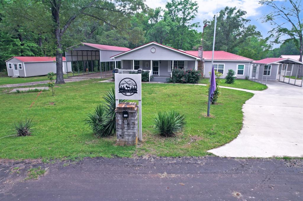This Lake Country home has no known restrictions and has leaseback on Glade Creek that leads to World Famous Lake Fork, and the leaseback has a fishing pier already in place. At full lake levels access to Lake Fork is no issue! This 2,630 sqft home features lots of recent updates; deep water well and co-op water, all metal roofing, siding, an 8'x35' front porch for enjoying the peaceful views, 3 bedrooms, 2 bathrooms, main living room with a stone wood burning fireplace, large family room with 20'x30' patio access to the outdoor stone fireplace and outdoor kitchen, 15'x22' indoor enclosed glass hot tub room with an exterior ramp for wheelchair access for the in-law that lives in your guest house. Guest house, built in 2025 with 720 sqft has full length covered porch with gorgeous views, 2 bedrooms and 1 bathroom. Would be a great rental for fisherman too. Property has a 12'x41' shed that has a finished out interior and previously used as an office. There is a 20'x60' RV cover and a 12’x20’ carport in front of the home. The all metal and steel frame 48'x32' shop building has 2 roll up doors and attached carports. All this sitting on 2.7 acres plus leaseback. Plenty of room here for all your family, pets, friends and your toys. This is one of those you must see to appreciate. Buyer to verify any and all information.