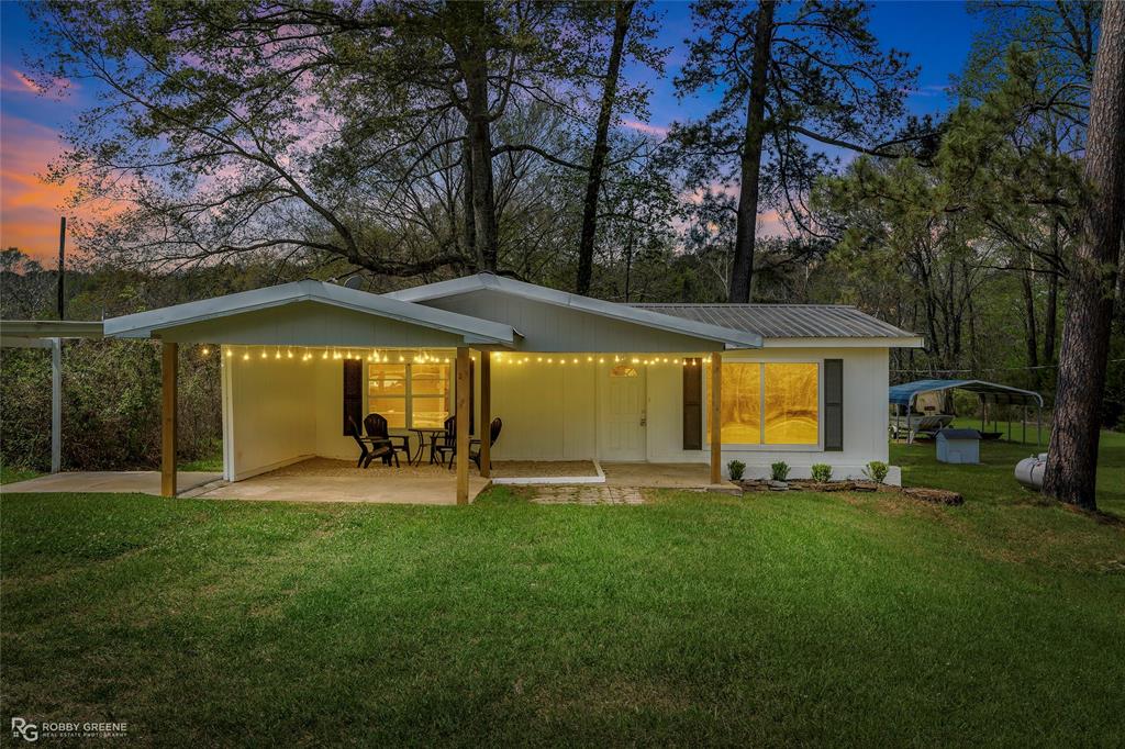 Welcome to this beautifully remodeled 2 bedroom, 1 bathroom waterfront retreat set on 1.33 picturesque acres with over 200 feet of frontage on Prairie Bayou, which flows directly into Lake Bistineau. Offering the perfect blend of modern comfort and outdoor lifestyle, this property is just minutes from the state park and provides easy access to boating, fishing, and year round recreation. Inside, the home has been thoughtfully updated from top to bottom with stylish finishes and modern conveniences. Major improvements include a brand new HVAC system, a brand new tankless hot water heater, and a durable lifetime metal roof, giving you peace of mind for years to come. The interior offers a clean, inviting feel that is move in ready and ideal for full time living, a weekend getaway, or a short term rental investment. Step outside and experience everything this property has to offer. The expansive acreage provides both privacy and space to enjoy the natural surroundings, while the bayou frontage creates a true waterfront lifestyle. Whether you enjoy fishing right from your property, kayaking through the bayou, or heading out to Lake Bistineau, this location is perfect for outdoor enthusiasts. Additional features include a gravel boat slip for easy water access, a powered workshop for projects or storage, and a large covered carport designed to accommodate boats, ATVs, or other recreational equipment. There is plenty of room to expand, entertain, or simply relax and take in the peaceful views. Whether you are looking for a serene escape, a place to entertain family and friends, or an income producing investment, this rare waterfront property offers endless possibilities with all the major updates already completed.