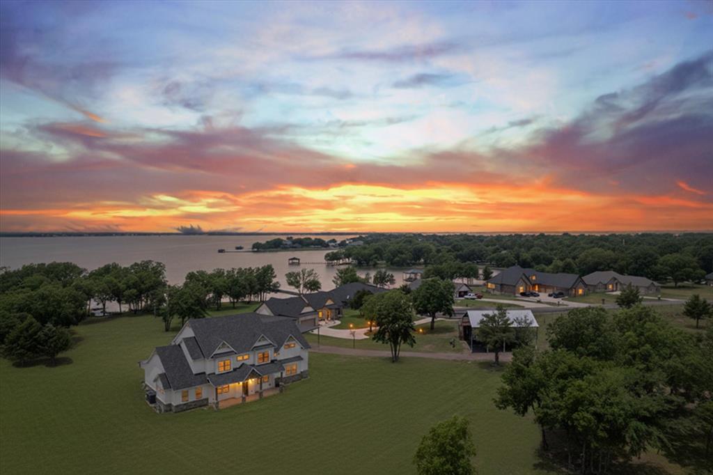 PRICE IMPROVEMENT AND ADDITIONAL PURCHASE OPTIONS!!Lakefront Luxury with Flexibility & Income Potential!
Experience the ultimate in peaceful lake living on Richland Chambers Lake with this stunning property! Originally over 17 acres of beautifully maintained land, there is now a purchase option to split off 12.77 acres, leaving the main home on a private 4.65-acre tract—perfect for those seeking a manageable, lakefront lifestyle. See MLS #21130046 for reference.
Step inside this exquisite home and be captivated by lake views from every room, soaring ceilings, 8-ft doors, and an open, family-friendly layout. The kitchen features tall custom cabinetry, quartz counters, tile accents, and an oversized island, ideal for gatherings.
The primary suite is a private retreat, boasting wood and beamed ceilings, a sitting area, a spa-like bathroom with jetted tub and oversized shower, and a closet with built-ins. Upstairs offers three additional bedrooms, two baths, and a flexible space perfect for a media room or second living area.
LOOK CLOSELY and you will discover SECRET rooms HIDDEN behind book shelves, window seats with storage and more! This LARGE home has SPRAY FOAM INSULATION  which makes for LOW energy bills!Outside, you’ll find a 2,000 sqft workshop with plumbing and electric, RV hook-ups, and ample room to build cabins—an ideal setup for short-term rentals or additional income opportunities. With nearly 700 linear feet of water frontage, this property blends lakefront luxury with country tranquility.
Conveniently located just off the highway, this property offers easy access while still feeling like your private lakeside retreat. Don’t miss your chance to own a slice of paradise with options to fit your lifestyle!