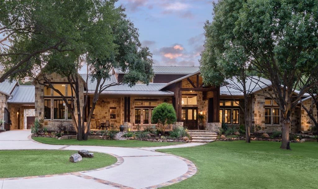 A remarkable find on rare gated 5.446 acres in the heart of the city. Striking double front doors open to the commanding large foyer within eyesight of all extensive gathering spaces. Wood trellises, tall soaring ceilings, walls of windows + French doors view the fabulous outdoor venues + lush landscape. Open concept design built for entertaining needs year round with luxury ammenities throughout. 4 FP in dining, kitchen, large living room + extended covered veranda w remote screens + built-in grill + kitchen + 2 large screen TVs + extensive sound system. 720 sqft main bedroom w 2 separate baths, each with shower, tub and grand closests. Kitchen w dual dishwashers, digital wolf range, dual islands. 2 extra large offices + wine room + FULL HOME GENERATOR + 7 car epoxy garages w extra large AC'd workshop + bath. Both 1,437 sqft finished loft w  elevator + fully equipped 700 sqft 2 rm guest house NOT INCLUDED in sq footage! Water well. NO HOA. Close to DFW, exemplary schools.