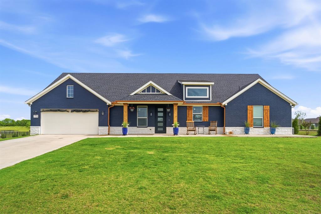Charming Single Story Home on 1 Tranquil Acre with Designer Touches! No neighbors behind! Timeless curb appeal showcases a painted exterior, welcoming front porch with cedar accents...a relaxing place to enjoy country living. Thoughtfully planned split 4-bedroom floorplan has upgraded finishes throughout. The very large living room features a cozy corner wood-burning fireplace, creating an inviting space for everyday living. Fourth bedroom with a closet, can be a dedicated office, providing flexibility for those working from home, a game room, or study space. Dramatic & impressive describes the gourmet kitchen boasting quartz countertops, pendant lights over the large center island, abundant cabinet storage & counter workspace + an open flow to the living-dining areas. Decorator details throughout the home include plantation shutters, upgraded lighting, luxury vinyl flooring everywhere, beautiful board & batten accent walls that add warmth & character.  The sellers created a screened-in dog porch for your beloved pets. An upgraded Class 4 hail-resistant roof + foam insulation in the attic make this home super energy-efficient! Unlimited possibilities beyond the home into the backyard. Add a future pool, workshop-out building, guest house. With a balance of charm, comfort & modern style, this home offers the ideal blend of indoor & outdoor living on a deep 1-acre lot. Make Your Move To This Enviable Country Retreat Today!