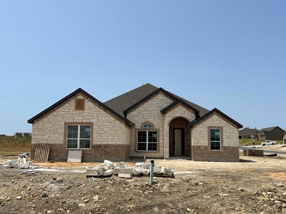 Energy Star Certified home with spray foam insulation! Beautiful open concept kitchen and living area, Study option, Formal Dining, Huge Kitchen Island, 12ft. Ceilings in entry and family areas, 10ft. ceilings throughout, cabinetry in utility room, mud bench, luxury vinyl plank in main areas, separate vanities, large corner shower & separate tub in primary suite, Flint Stained shaker style cabinets, 3 CM Blizzard Quartz in kitchen and utility plus stone quartz in baths, and much more!