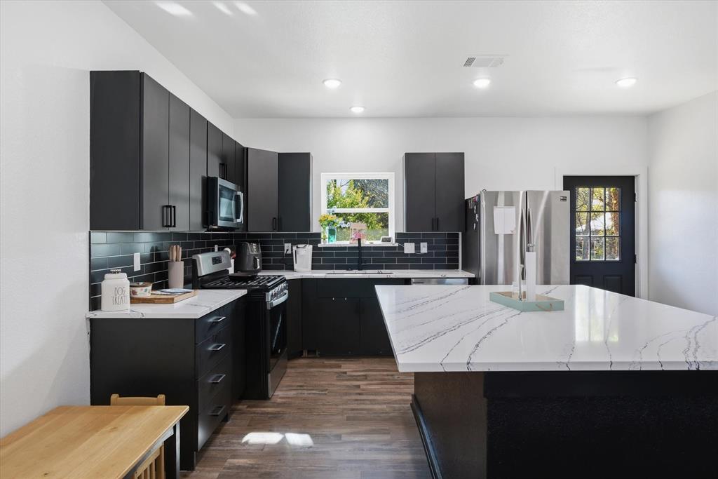 This beautifully designed split-level home in Grand Saline, built in 2025, offers the perfect blend of style, functionality, and location. Conveniently situated near local schools, it’s an ideal choice for anyone seeking easy access to town amenities.
Inside, a striking black-and-white color palette creates a modern, cohesive feel throughout the home. The kitchen is both stylish and practical, featuring sleek stainless steel appliances, ample cabinetry, and a central island that serves as the heart of the space. The island opens seamlessly into a spacious second living area, making it perfect for entertaining or relaxing with family. This versatile living space also provides direct access from the back entry, adding convenience and flexibility to the layout.
The home offers three comfortable bedrooms and two full bathrooms, thoughtfully arranged to provide privacy and functionality. With its split-level design, contemporary finishes, and inviting layout, this property is a standout opportunity in a great location.