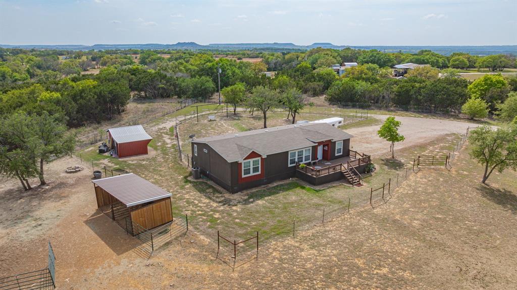 Escape to peaceful country living on 3.6 acres with this beautifully maintained and functional property, fully fenced and cross fenced perfect for horses, livestock, or anyone wanting space to spread out.
This 3 bedroom, 3 bathroom home with 1,680 square feet offers an inviting open-concept layout filled with natural light. The spacious living area features built-ins and flows seamlessly into the kitchen, complete with a large island, abundant cabinetry, and charming farmhouse touches including a sliding barn door.
The primary suite is a true retreat with double vanities, a soaking tub, and a separate shower. Additional bedrooms are generously sized, providing plenty of room for family or guests.
Step outside and enjoy everything this property has to offer. The home is positioned toward the back of the property, allowing the front porch to overlook your pasture creating the perfect space to relax, entertain, and take in stunning sunrise views. An outdoor kitchen setup adds even more functionality for hosting and enjoying the country lifestyle.
The land is thoughtfully set up with cross-fencing, multiple pens, and a horse shelter, making it ready for your animals from day one. The property backs up to an additional 400 acres, offering exceptional privacy, open views, and a true country feel.
This beautiful property combines comfort, functionality, and privacy ready for you and your animals.
