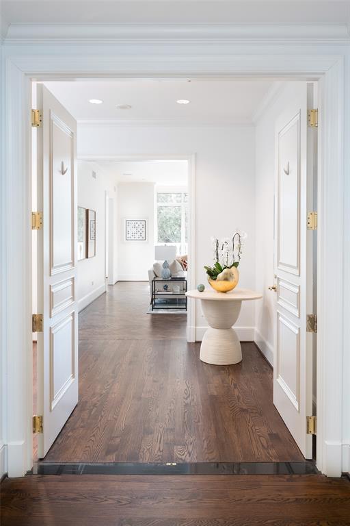Specimen trees verdantly envelope this convenient lower level unit at the prestigious Vendome on Turtle Creek, the anchor high rise along the TC corridor! Sleek and filled with an abundance of natural light, the unit is introduced via private elevator, which opens to vestibule and foyer! Site lines lead to expansive balconies on each end of the unit. Beautiful hardwood flooring and museum flat walls throughout; the living room boasts a herringbone pattern. Fireplace adorns west wall. Primary Suite is enhance by 2 baths, all appointed in marble. Handsome corridor with wet bar leads to open space gourmet Kitchen and Dining Room, open to north balcony. Split ensuite bedroom aside a short hall as are Laundry and Service Access!