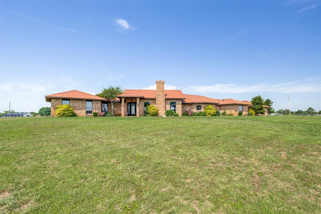 BEAUTIFUL, fully remodeled ranch home with metal roof on 5 acres with breathtaking views and mature trees.  This gorgeous custom home is a must see!  The spacious kitchen offers a double island, built-in sub zero refrigerator, ice maker, double oven, cook top with griddle, microwave, and exquisite granite countertops.  The spacious primary suite features a luxury bathroom with a large whirlpool bath with stone surround.  Decorative lighting, beautiful wood features and custom built-ins throughout the house.  Both interior and exterior have been repainted.  The updated pool (2025) is enclosed by a 4 foot wrought iron fence.  Enjoy spectacular sunsets and beautiful pond view on the back patio.