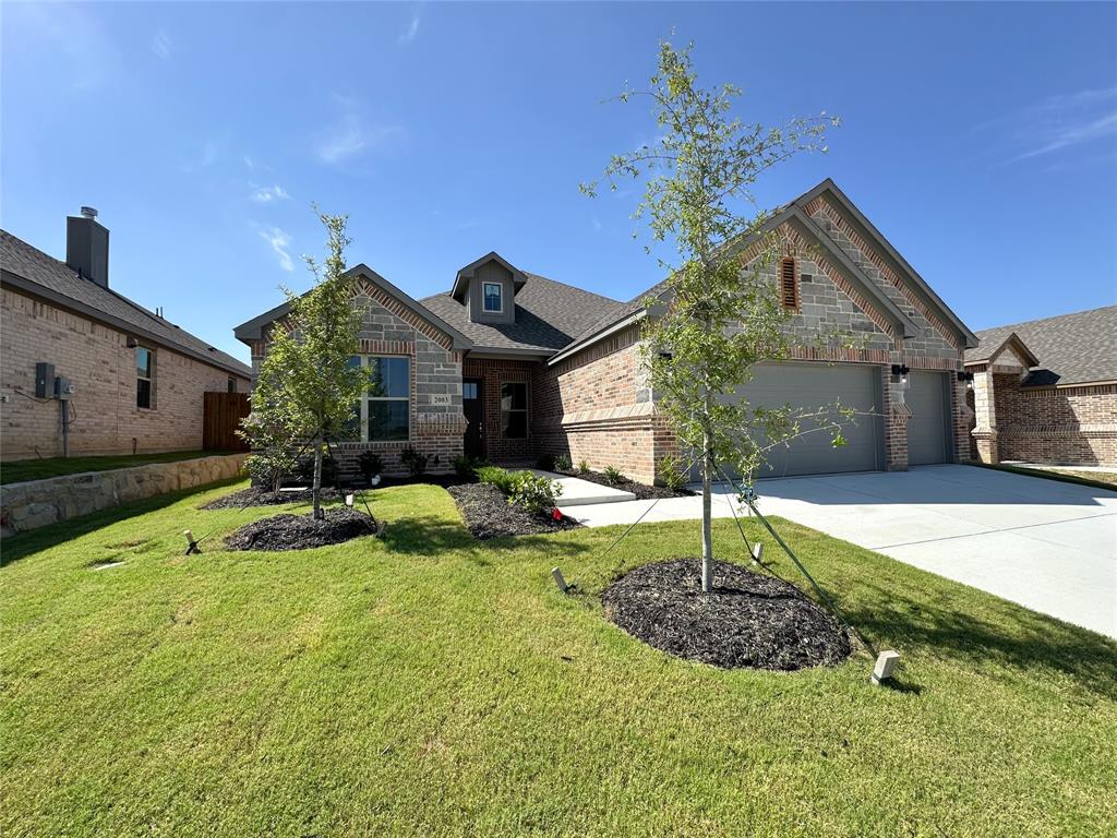Seller is offering $7500 buyer incentives  This beautifully crafted home has a large open kitchen custom cabinetry with 42in uppers large granite island with undermount 50 50 sink and concealed trash cabinet. The stainless Whirlpool appliances make this kitchen a chefs dream Elevated ceilings with double crown molding in living area single stage in kitchen, dining, entry and primary. Oversized 5.25 baseboards throughout. Ceiling fans with light in living and primary, guest bedrooms are wired as well. Luxury water resistant vinyl plank flooring in the main areas and hallway. Full security. Energy efficient windows throughout. Primary bathroom has fully tiled showers with accent flooring. The exterior is beautifully designed with brick and decorative stone. An insulated 3 car fully finished garage offers plenty of room and has neatly textured walls and baseboards. Encapsulated foam insulation for highest energy efficiency. A full sprinkler system takes care of the front landscaping 2 trees as well as the nice size backyard.