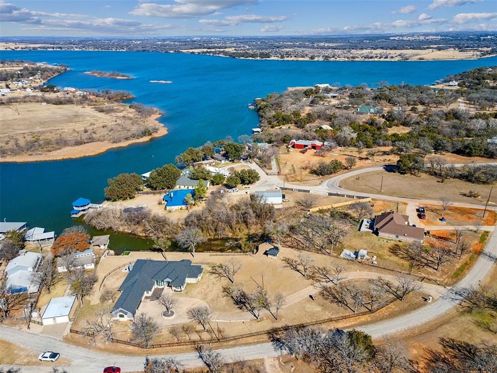 OPEN HOUSE SAT 11-1PM. Presenting 2100 Gene Ct. Over 1.6 acres of lakefront property with a beautiful 4 bedroom home and no HOA. A completely remodeled 3,464 sq. ft. sanctuary that blends modern sophistication with the charm of lakefront living. This home is the perfect retreat for those who want to unwind in style, yet still have room to entertain (and let's be honest—show off a little). The previous dock was removed and there is space for a new one to be installed. 

Boasting 4 spacious bedrooms and 3.5 bathrooms, this home has room for everyone—whether it's family, friends, or your collection of wine glasses that really deserve to be on display. Speaking of entertaining, you’ll never run out of space. There’s a generous living room for cozy gatherings and not one, not two, but three game room areas. Perfect for turning any rainy day into an unforgettable experience—or just a really competitive game of pool or shuffleboard.

The house is beaming with natural light thanks to the wall of windows that invite the outside in—because, why would you want to miss the views of your private lakefront? And speaking of views, the covered patio is the perfect spot to sip your morning coffee while you take in breathtaking sunsets over the water. Yes, we said breathtaking. It’s that kind of place.

The home underwent an extensive remodel in 2024, just in time for you to ring in the summer season with a fresh, stylish space. The kitchen features top-of-the-line appliances, ample counter space, and a vibe that says, I cook, but I also enjoy a good glass of wine while doing it. 

This home offers a blend of luxury, convenience, and a slightly unfair advantage in the sunset department. Ready to make this dream your reality? Schedule your private showing today—before someone else beats you to the most coveted lakefront address in Granbury.