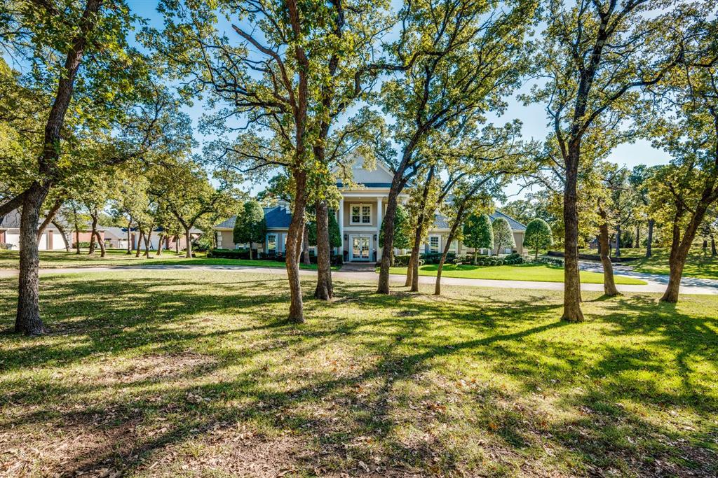 Beautiful Custom Built Home sitting on over 4 acres in Dalworthington Gardens. Upon entering the property its gated with a security camera. It features a private lake in the back of the 4.17 acres. Fish from you backyard or have a perfect place to built a dock to sit on the lake. Main bedroom is downstairs with private panic room & large office. The home was built for entertaining with 4 living areas & a bar opening up to the living room. Has a game room as well as a Theater room upstairs. All bedrooms have their own private bathroom. With a 4 car garage & lots of parking space to accommodate any size family. Beautiful diving pool also has an attached spa. Full oven for cooking outside sits under the covered outside living area & also features a beautiful pergola. New storage building in the backyard. Sprinklers are connected to the private lake to maintain watering the yard year round. Land is zoned for livestock.