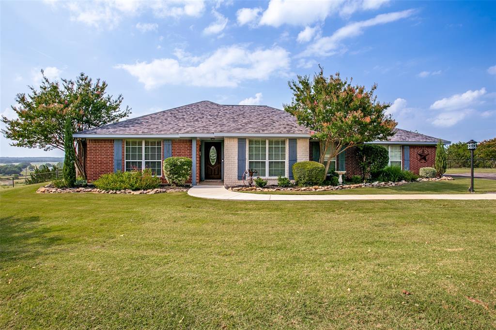 Welcome home to this beautifully maintained brick residence situated on over five picturesque acres, offering privacy, comfort, and convenience. Step inside to an inviting open-concept living area highlighted by an electric fireplace with a beautiful hearth. The kitchen is a true standout, featuring a center island, stainless steel appliances, granite countertops, and a spacious pantry. Updated luxury vinyl plank flooring flows throughout the main living areas, complemented by new carpet in the bedrooms. A formal dining room at the front of the home offers versatility and can easily be used as a playroom, home office, or flex space to suit your lifestyle. The remote primary suite provides a peaceful retreat with a large walk-in shower, dual sinks, and a generous walk-in closet. Enjoy outdoor living year-round on the expansive covered patio, overlooking the fully cross-fenced property—ideal for animals or hobby farming. Additional features include a 16x16 workshop with electricity and a private well to water the property, keeping it lush and green. Located just minutes from the HEB shopping area, you’ll enjoy quick access to dining, entertainment, and everyday conveniences. Residents of Bentwater on Lake Granbury have access to a community park, ponds, and a clubhouse available for private events or community gatherings. Boat dock slips are also available for lease, allowing you to fully embrace the Lake Granbury lifestyle. This exceptional property offers space, functionality, and a vibrant community—an opportunity not to be missed.