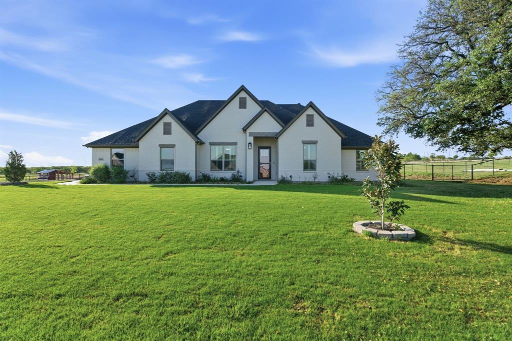 Located just outside of Poolville, this beautifully maintained 5-bedroom, 3-bathroom home offers 2,728 square feet of well-designed living space with a functional layout that is inviting for multi-generational living or hosting guests. The all-brick home features a warm and inviting living room with coffered ceilings and a gas log fireplace, creating a comfortable space to gather, while the kitchen provides ample storage and workspace for both everyday living and entertaining. The spacious owner’s suite is filled with natural light and offers a peaceful private retreat at the end of the day.

Step outside and enjoy a huge covered back porch, perfect for relaxing and taking in the quiet country setting. Mature live oak trees and well-maintained landscaping surround the home, adding both beauty and privacy. The property is fully fenced with pipe fencing and no-climb wire, making it well-suited for animals or a small hobby operation. A large insulated metal shop with electric roll-up doors offers excellent space for equipment, projects, or additional storage. A whole-home generator provides added peace of mind, ensuring comfort and reliability year-round.

Conveniently located near Weatherford and within easy reach of the DFW Metroplex, this property delivers the space, functionality, and country lifestyle that buyers are looking for.