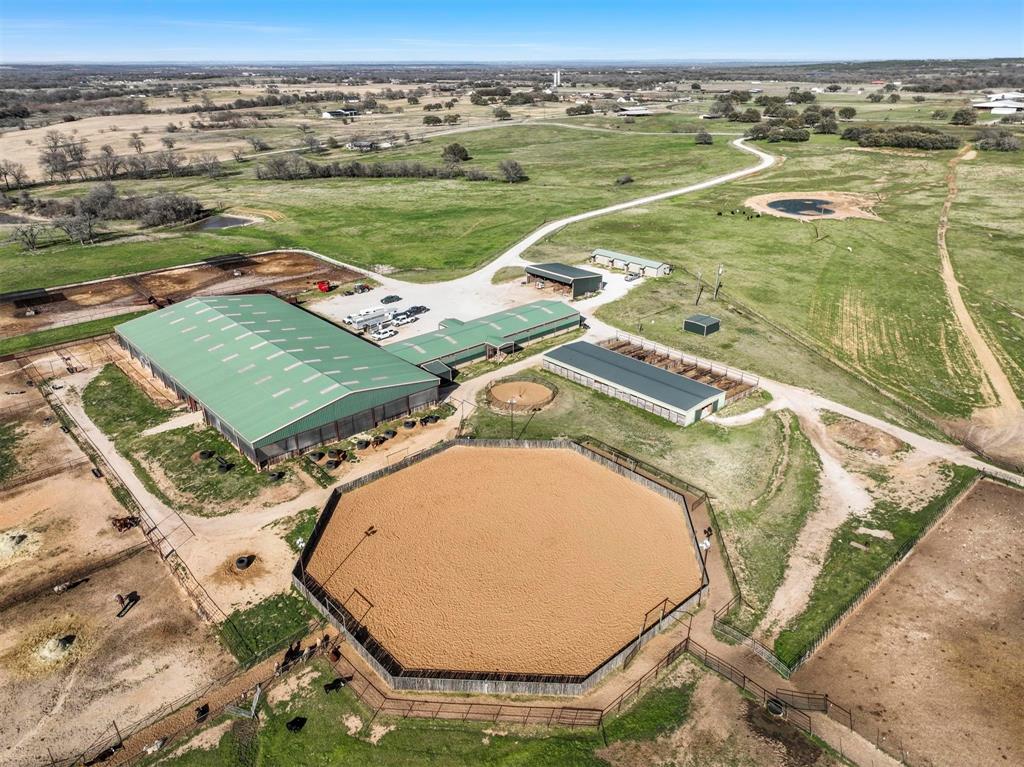 Income producing Equestrian and Cattle Property in the heart of cowboy country with multiple residences, two large homes, one apartment, and a four bed four bath bunkhouse. Covered arena, 37 stalls, outdoor arena, and working cattle pens. Previous home to Kasen York Performance Horses. This premier equestrian property spanning 123± acres, just one hour west of Fort Worth. Perfectly blending residential comfort with professional grade equestrian and cattle facilities, this property offers an exceptional opportunity for horse enthusiasts or professional trainers. Residential features include two recently updated homes, ideal for hosting guests, accommodating staff, or enjoying your own private living quarters, new apartment with one bedroom 1.5 bath, bunkhouse with four private rooms and laundry. Equestrian facilities include two Barns with 37 total stalls, additional pens and traps, cattle lanes, outdoor 150 ft octagon arena, covered arena 120x250, new 8 horse walker covered, restroom, and washroom, perfect for hosting events or competitions. Additional features, equipment barn-hay and large shop for secure storage. RV hookups. Three ponds adding both natural beauty and functionality to the property. This property is more than a ranch—it’s a fully equipped equestrian paradise with endless potential. Whether you’re looking to host events, train professionally, or enjoy a private retreat, this property delivers the perfect balance of lifestyle and functionality. All ranch equipment negotiable; cab tractor, arena drag, skidsteer, two side by side atv's, and manure spreader.