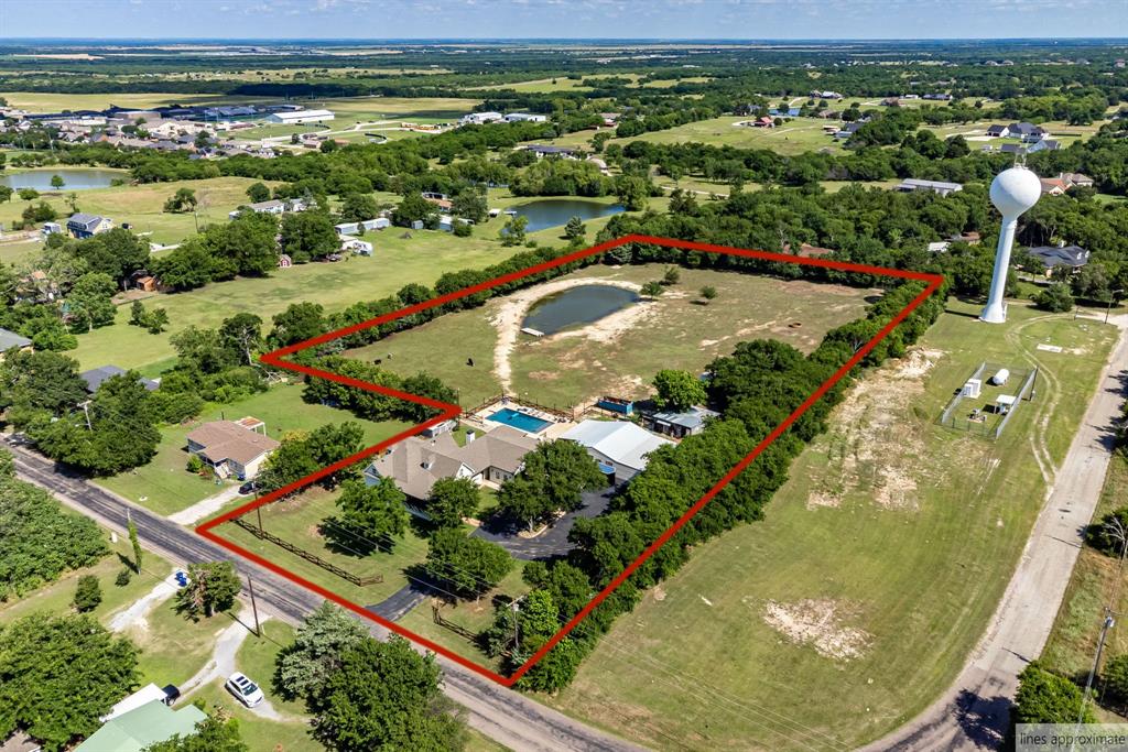 Modern Country Estate on 4+ acres in the highly desirable Gunter ISD! Blending original 1930s character with a massive expansion and complete remodel finished in recent years, this spectacular property offers nearly 4,000 square feet of high-end living space. Designed for effortless modern living, the expansive floor plan features 4 bedrooms, 3 full bathrooms, and 3 distinct, flexible living areas that provide plenty of room for family, guests, and everyday entertainment. A full video surveillance system is included for added peace of mind.

Step outside to a private backyard oasis engineered for ultimate Texas outdoor living. The property boasts a pristine dive-depth swimming pool, perfectly paired with a premier covered outdoor kitchen pavilion. This incredible space serves as the ultimate hub for weekend entertaining and relaxed country evenings. For hobbyists, mechanics, or business owners, a massive asphalt driveway leads back to a sprawling 1,200 SF detached workshop featuring an 800 SF covered lean-to, offering incredible storage and workspace for classic cars, heavy equipment, or major projects.

The acreage is a true recreational haven, spanning just over 4 acres that are fully fenced and cross-fenced. Enjoy a completely turnkey land management experience, as the tractor and matching implements are included with the property. Livestock and animal lovers will appreciate the secure, gated 3+ acre pasture alongside multiple barns on the property. You can also cast a line right in your own backyard from a private, lined, and fully stocked pond teeming with bass, crappie, and catfish. Located just minutes from the heart of Gunter and zoned for top-rated, highly acclaimed Gunter schools, this rare estate offers an unparalleled lifestyle where modern luxury meets true country freedom.
