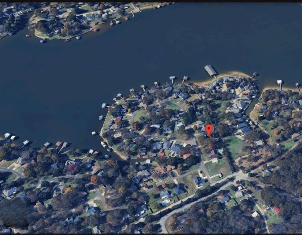 Located in a well established, gated lake community, this lot offers the perfect opportunity to create your ideal getaway or full-time residence. Nestled among mature trees and surrounded by nature, the property provides a peaceful setting just moments from the water. Residents enjoy exclusive access to community amenities such as a gated entry, private boat ramp and pier and well-maintained. Whether you're looking to build now or invest in the future, this lot offers the perfect blend of seclusion, security, and lake lifestyle. Utilities are available at the street. Don't miss your chance to own a piece of lake paradise!