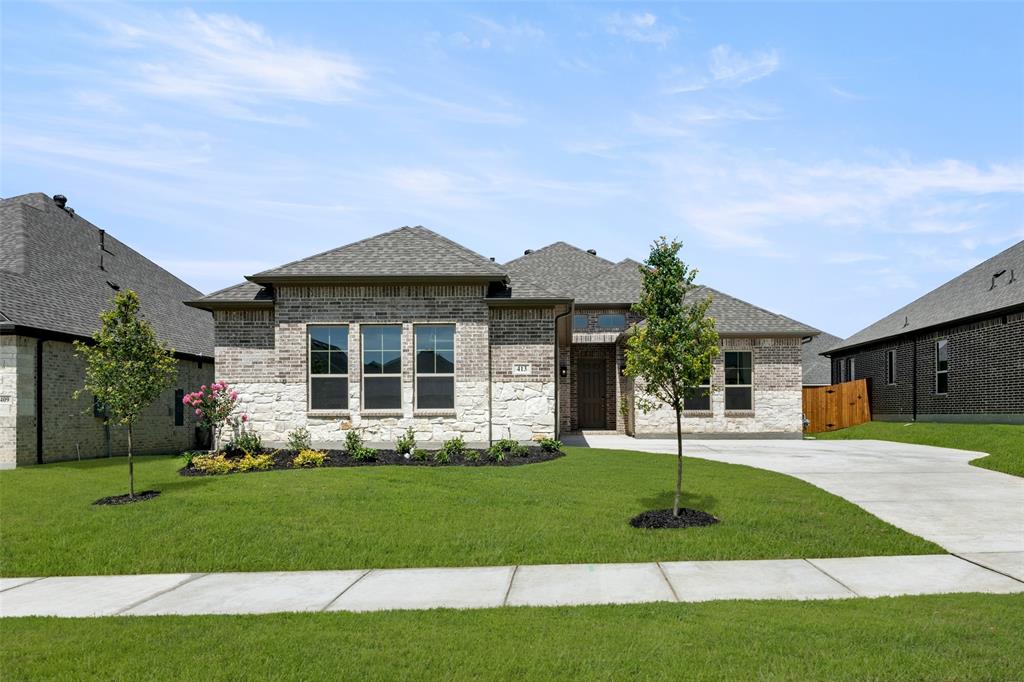 MLS# 20976860 - Built by Sandlin Homes - Ready Now! ~ Our Redwood JS plan with 4 bedrooms, 3 bathrooms, an open living room, fireplace, kitchen island and a covered patio. This home is designed with 3cm marble countertops, white cabinets, a wrapped island, carpet, upgraded tile and laminate flooring, and a tiled fireplace.