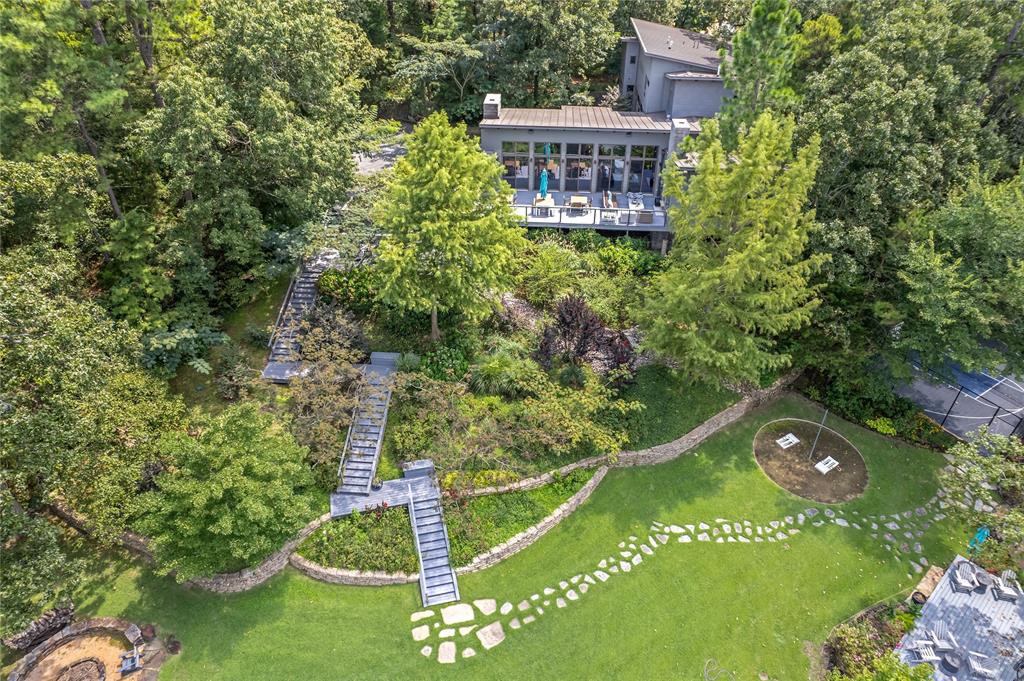 This beautiful compound on Lake Cypress Springs includes the rare opportunity to own a contemporary home in a private setting on 4.5 acres. The gated entrance leads you to one of the largest lake lots with a custom home designed by well-known architectural firm Barry Bull Ballas. An expertly designed 4 bedroom and 5 and a half bath home with exterior combination of stone, zinc and hardy produces a timeless home nestled among the towering trees and perfectly oriented on the land to maximize the views of the lake with over 450 ft of lake frontage. The property boasts all the recreational options you can imagine. Sport court ideal for pickleball, basketball, foursquare, shuffleboard and badminton. Multiple boat docks including an automatic lift and cover for a ski boat, a pontoon boat and a floating dock for swimming and additional watercraft. Expert landscaping surrounds the home and lakefront with additional features including a fire pit, beach area, spa, tetherball area, multiple decks and seating areas. Included in the sale is a 2011 Sun Tracker Pontoon Boat with 150 Mercury 4 stock engine covered lift, Kawasaki UTV 4.4 Mule, two 2021 Sea-Doo Jet Skis, three kayaks and one paddleboard. This sophisticated lake house with countless recreational options is ready to enjoy.