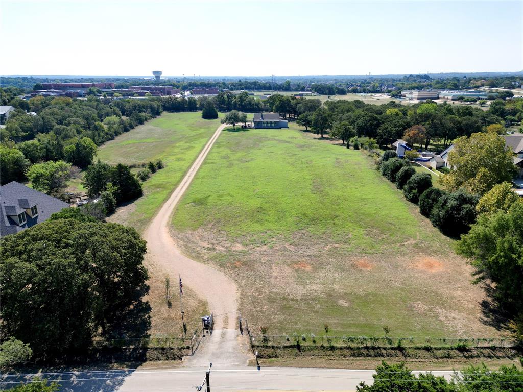 Builders Dream or a rare chance to own almost 7 acres nestled in the heart of Southlake with a wide open perfectly sloped lot. This property promises both tranquility and space in a sought-after location. A unique offering consists of four parcels being sold as one property. The property is highlighted by its mature trees and vast open spaces, perfect for gardening enthusiasts, those looking to create a play area or anyone who simply wants to enjoy the serene natural surroundings. A very livable quaint remodeled farm style home with large porch and spacious attached three car garage, sits on the far side of this property which is ideal for immediate use, renovation or could be lived in while building.  Flexibility to subdivide this rectangular lot into several parcels. This home features 3 bedrooms, 2 full baths and half bath, and a large kitchen w breakfast sitting area, Whether you choose to renovate the existing home, expand it, or build your custom dream residence, this property provides endless possibilities. This peaceful setting looking out over the land coupled w abundant possibilities makes it a unique find in Southlake.
