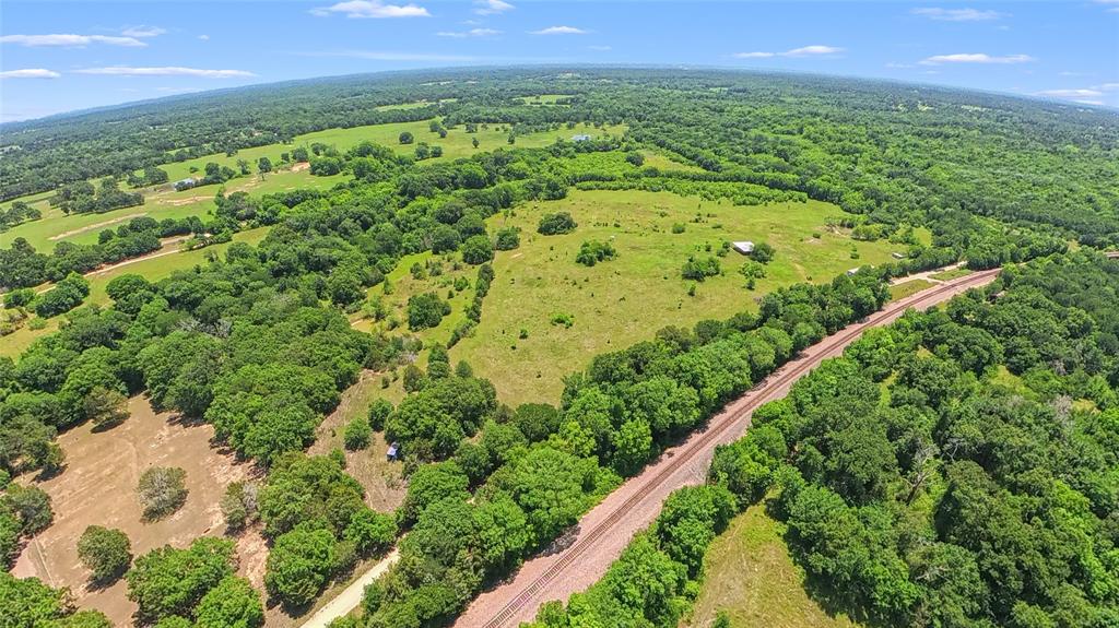 This unique 65+- acre tract offers the best of both worlds! Productive pastureland paired with heavily wooded recreational acreage rich with wildlife, water features, and natural beauty. Approximately 27+- acres of high and dry pasture are currently being utilized for cattle and horses, making it ideal for livestock, hay production, or a future homestead site.

The remaining acreage is densely wooded with mature trees, abundant wildlife, rolling elevation changes, and a secluded pond tucked away within the timber and fed by scenic Tehuacana Creek, which winds through the southern portion of the property. Whether you enjoy hunting, fishing, trail riding, or simply exploring the outdoors, this land offers endless opportunities for recreation and relaxation.

Approximately 38+- acres fall within the floodplain and freshwater-forested wetland areas, creating a thriving habitat for wildlife and adding to the property’s natural character and privacy. Multiple beautiful build sites can be found throughout the higher elevations overlooking the land.

A barn is already in place, electricity is available at the road, and the property sits above a shallow aquifer, making a water well a great possibility for those dreaming of country living. Convenient access from both FM 80 and FCR 1110 adds flexibility and ease of use.

Located less than 5 minutes from I45 and approximately one hour from Downtown Dallas, this property offers the peace and freedom of rural Texas living while still maintaining an easy commute. Whether you’re looking for a recreational getaway, hunting property, grazing land, or future homesite, this one is a rare find with incredible versatility.