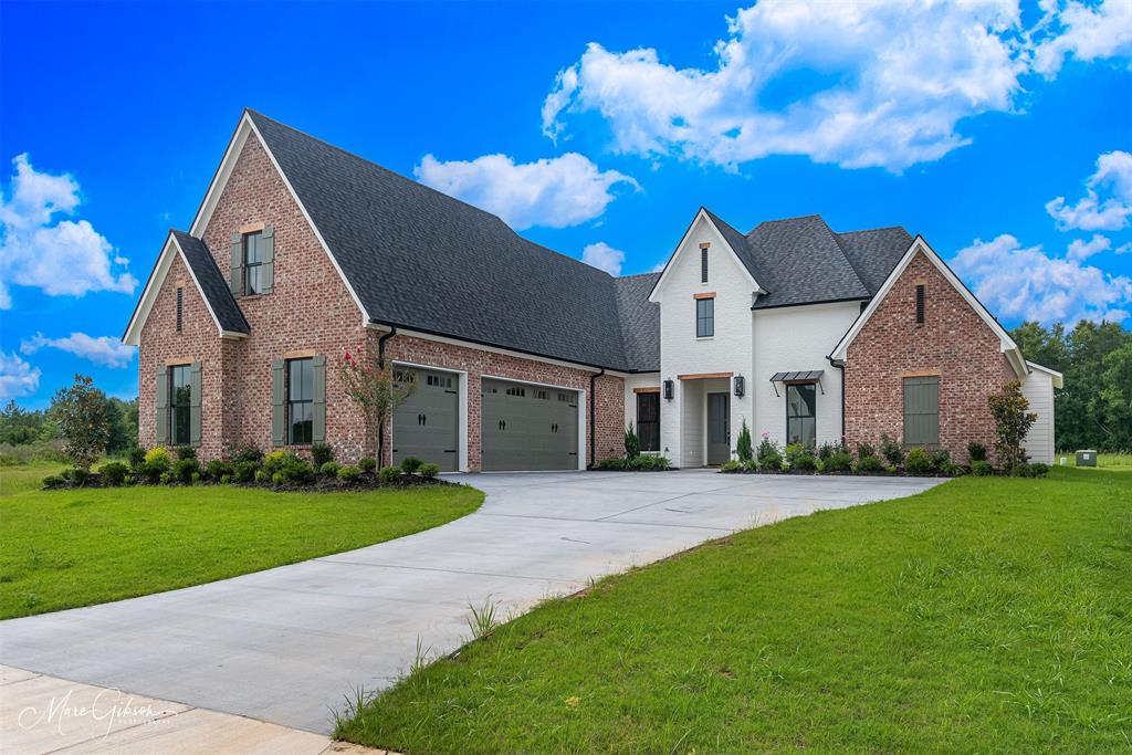 Gracious living awaits in this gated South Shreveport community.

Step inside to a light-filled, open-concept design where a striking fireplace with custom built-ins anchors the living area, seamlessly flowing into the dining space and a chef-inspired kitchen. A sophisticated blend of white oak stained and painted cabinetry is paired with quartz countertops, an integrated quartz sink, and a statement champagne bronze faucet with quartz and wood accents. A full quartz backsplash with discreet under-cabinet outlets, layered lighting above and below, a 6-burner GE Café range, wall oven, microwave, and a spacious pantry with a deep quartz shelf—perfect for a coffee bar—make this kitchen ideal for everyday living and entertaining.

Expansive windows in the great room overlook the backyard and a 29-foot covered patio featuring a painted brick fireplace, griddle, 2-burner cooktop, undercounter refrigerator, and sink—designed for effortless outdoor living. Opposite the main living area, a versatile office, music room, or playroom with French doors and a front-facing window offers flexibility and privacy.

The main suite features large windows, an oversized walk-in closet with built-ins and pull-down hanging space, and a luxurious bath with dual vanities, soaking tub, tiled shower, and private water closet. Two additional main-level bedrooms share a bath with separate vanity areas.

A generously sized utility room includes a sink, cabinetry, and ample workspace. In the hallway is a beautifully finished powder room. A spacious upstairs bonus room or bedroom with walk-in closet and private bath provides the perfect retreat for guests or teens.

Additional features include app-controlled garage access and connection for a water filtration system.
