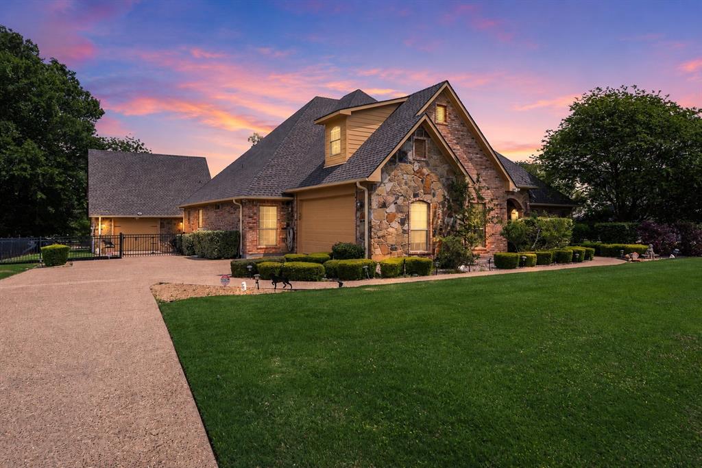 Welcome to lake living in The Shores on Richland Chambers Lake, where Hill Country charm meets comfort and functionality. Situated on a .523-acre canal-front lot with water views, this 5-bedroom, 3.5-bath home offers over 3,000 sq ft of inviting, open-concept living designed for relaxing weekends and effortless entertaining.

Inside, you’ll find warm wood flooring, arched walkways, crown molding, and a light-filled living area with custom built-ins and backyard views. The kitchen is designed for gathering with granite countertops, a large island, walk-in pantry, breakfast bar, and a beverage station with wine fridge. A private office with French doors and multiple dining areas add flexibility.

The spacious primary suite features a soaking tub, separate walk-in shower with body sprays, dual vanities, and generous storage. Additional bedrooms include a Jack-and-Jill layout, ideal for family or guests.

Outdoors, enjoy peaceful mornings, sunset evenings, and easy access to the water with a covered patio, fire pit, and mosquito misting system. The property includes a private boathouse with lift, plus Boat Slip #19 in The Shores marina—giving you the best of both worlds with private dock access and quick entry to open water.

A detached structure adds versatility with a 625 sq ft workshop below and a 450 sq ft efficiency guest apartment above, complete with kitchenette—perfect for guests, extended stays, or potential income.

Additional features include a whole-home water filtration system and tankless water heater. Located in a gated community with marina, pool, clubhouse, fitness center, and more—this property is your gateway to enjoying the best of Richland Chambers Lake.