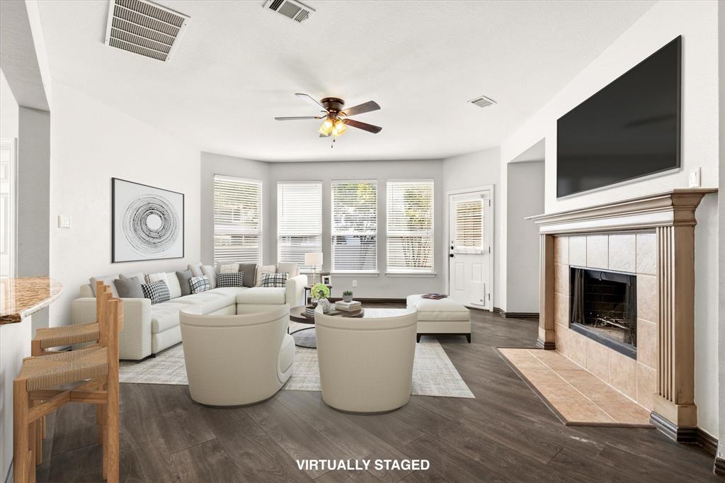 Welcome to this expansive, energy-efficient two-story home located in the master-planned community of Providence Village. A charming front porch sets the tone as you enter into a thoughtfully designed home spanning 2,600 square feet of living space. Inside, you’re greeted by wood-look laminate flooring, soaring 19-foot ceilings, and a formal dining area that flows seamlessly into the heart of the home.
The open-concept layout is ideal for entertaining, featuring an expansive living room with a cozy wood-burning fireplace and uninterrupted sight-lines into the kitchen and breakfast area—perfect for hosting gatherings both large and small. The kitchen is well-equipped for entertaining and everyday living, offering generous prep space with granite countertops, stainless steel appliances, a convection oven, island, and a butler’s pantry for added storage and convenience. Designed with comfort and efficiency in mind, this home includes 18 SEER AC units, added attic insulation, and smart home features such as a Ring doorbell and smart thermostats—helping you stay connected while maximizing energy savings. A full sprinkler system adds convenience for maintaining the outdoor space year-round. The first-floor primary suite provides a private retreat with an ensuite bath complete with dual sinks, a garden tub, separate shower, and a walk-in closet. Upstairs, the home truly shines as an entertainer’s space with a large game room and an oversized media room, ideal for movie nights, game days, or relaxing with family and friends. Three additional bedrooms and a full bath complete the second level, including one bedroom with access to a private balcony. Residents of Providence Village enjoy access to a variety of community amenities, including a resort-style pool, clubhouse with fitness center, scenic lake, fishing, walking trails, and more.