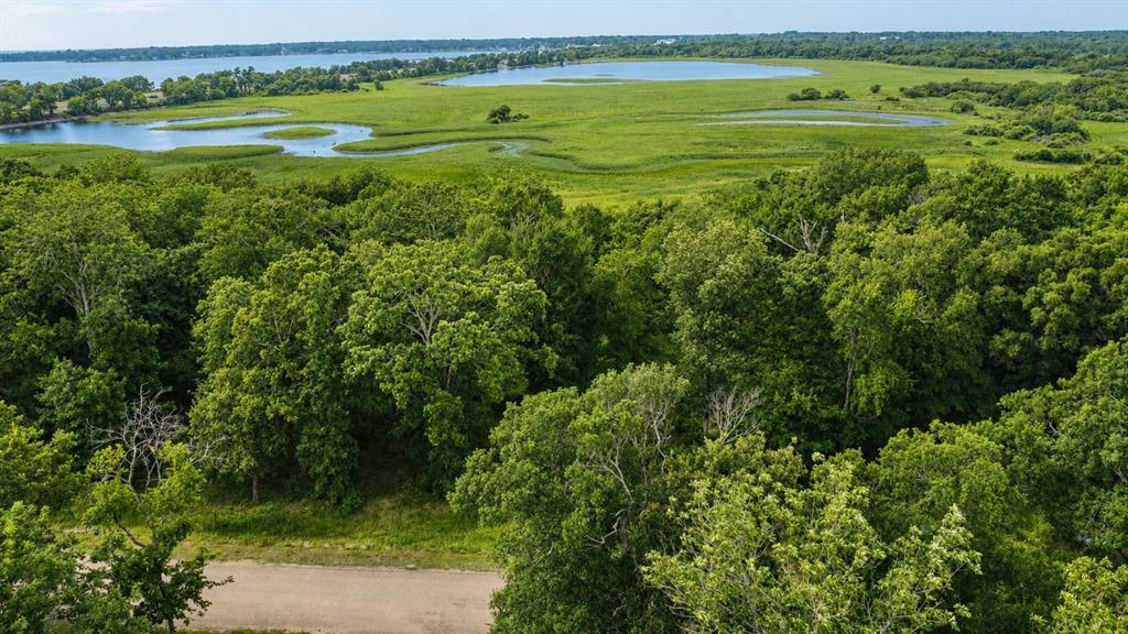 Take advantage of this 0.95 acre waterfront wooded lot situated in the sought-after gated community of Oakmont Estates with public utilities available. This waterfront property has been partially cleared for pad site and offers the perfect opportunity to build a custom home. Enjoy a quiet, private setting with convenient access to shopping, restaurants, schools, and nearby lake activities. A wonderful opportunity to own waterfront land in a highly desirable area.