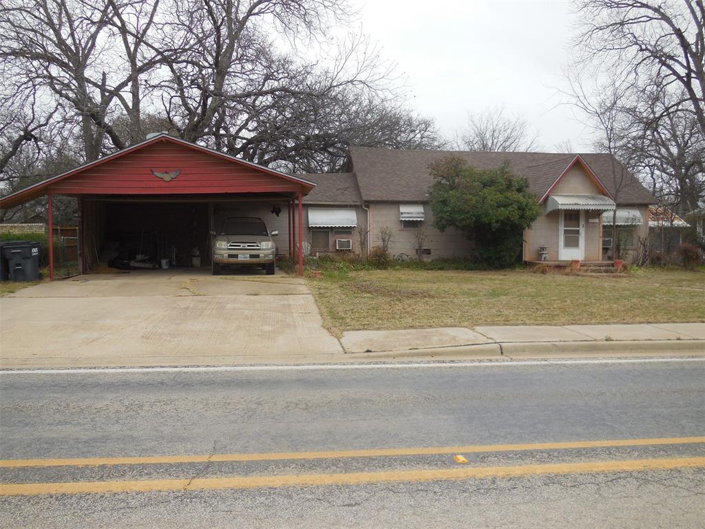 Cozy home with a great location on Main Street. 2 bedrooms, 2 bathrooms, living room, Dining room, Den that is open to the kitchen. There is a fireplace in the den with a very nice metal insert with doors. A separate mudroom from the carport entrance and a large utility room area. Part of the living room could be converted into a 3rd bedroom. Attached 2 car carport, fenced backyard with a workshop and storage area for tools, yard equipment, and other personal items. The composition roof is 4 years old.  There is a large pecan tree in the backyard. This would make a great home with all of the large rooms and closets.