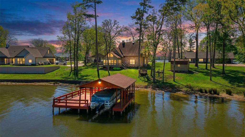 Your perfect waterfront retreat on Lake Bob Sandlin awaits! This beautiful 4-bedroom, 2.5-bath home is located in the highly sought-after Hopes Landing subdivision, offering both comfort and stunning natural surroundings.  The dining room showcases incredible views of the lake, creating the perfect backdrop for every meal. Enjoy breathtaking scenery year-round, with vibrant colors painting the landscape during the fall season.  Situated on nearly one acre, this property provides plenty of space for outdoor games, entertaining, or simply relaxing by the water. The thoughtfully designed layout features a spacious master suite on the main floor, while the additional bedrooms are located upstairs—ideal for family or guests.  If you’ve been searching for a lakefront home that combines beauty, space, and location, this is one you don’t want to miss. Schedule your showing today before it’s gone!