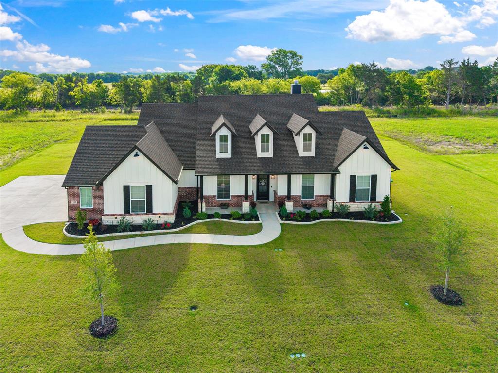 Completed in 2024 by Elmwood Custom Homes, this exceptional 4-bed, 2.5-bath custom residence offers the perfect blend of luxury, comfort, and thoughtful design on a picturesque 1-acre homesite. From the moment you arrive, the striking modern farmhouse elevation, extended driveway, landscaped flower beds, and expansive lot create unforgettable curb appeal.

Inside, vaulted ceilings and stained beam anchor the spacious living room, highlighted by a stunning fireplace with gas starter, custom built-ins and abundant natural light. The open-concept floor plan flows into the gourmet kitchen featuring custom shaker-style cabinetry to the ceiling with glass inserts, under-cabinet lighting, double ovens, gas cooktop, farmhouse sink, island with extensive storage, soft-close drawers, upgraded fixtures, and an extended walk-in pantry with appliance shelving. The adjacent dining area showcases elegant wainscoting.

The private primary suite offers a peaceful retreat with a spa-inspired bath featuring dual vanities, soaking tub, oversized walk-in shower, and direct access to the laundry room. Secondary bedrooms are generously sized, while the dedicated study offers flexibility for a home office, playroom, or media space.

Additional upgrades include overhead speakers in the kitchen and primary bedroom, custom mulled windows, French doors and transom window to the patio, upgraded carpet padding, crown molding, mud bench, utility sink in garage, 8-foot garage doors, Home Pro security system with cameras, Christmas light outlets, tankless water heater, 500-gallon propane tank, additional flood lighting, and an additional gas drop on the covered back porch.

Enjoy peaceful country living with room to roam, entertain, and create your dream outdoor oasis while still being conveniently located. The property also backs up to a future walking trail! This nearly new custom home delivers the quality, craftsmanship, and upgrades today's buyers are searching for.