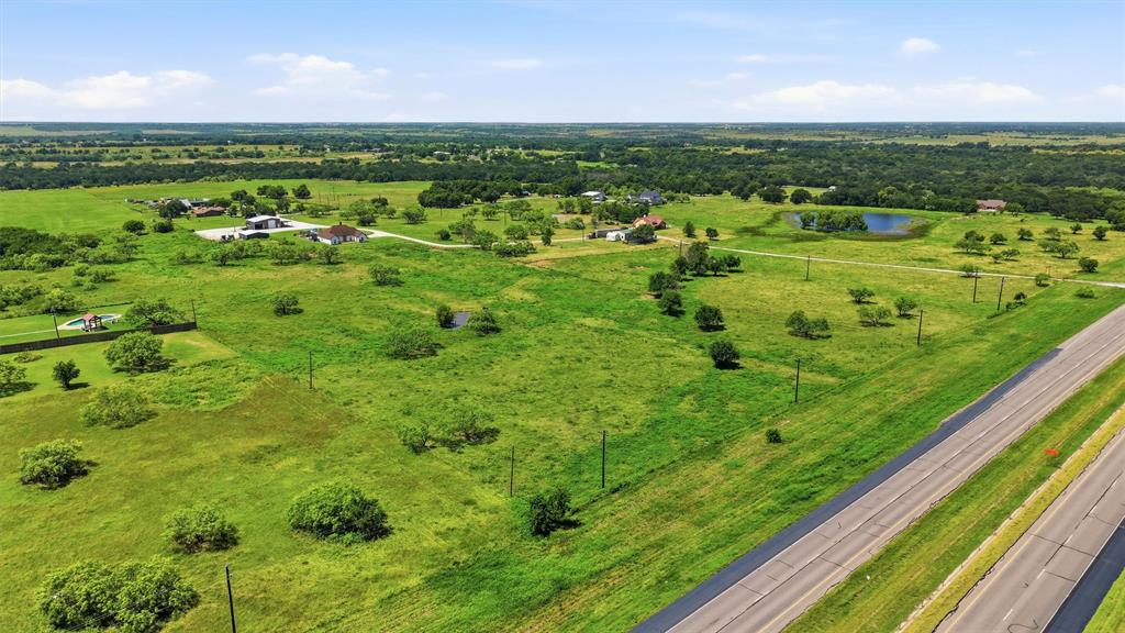 5.9 Acres in Sherman (S&S ISD). Discover the perfect blend of space, convenience, and opportunity on this 5.9 acre tract. With prime frontage along Highway 82, this property offers exceptional visibility and easy highway access, making it ideal for a variety of residential uses. The land is well-suited for a barndominium, custom home, or a multi-generational family compound, with plenty of room to design the layout that fits your lifestyle. Whether you envision a shop, guest house, wide-open pasture, or a private retreat, this acreage provides the flexibility to build exactly what you need. Enjoy the peace of country living while staying close to Sherman’s rapidly growing development corridor, major employers, shopping, and everyday conveniences.
