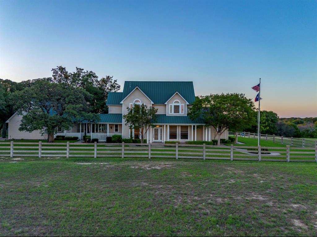 Discover a rare gem just minutes from downtown Fort Worth in the highly coveted Eagle Mountain Saginaw ISD — a breathtaking country estate that seamlessly blends elegance with natural beauty. This unique one owner property showcases exquisite craftsmanship with hand-done woodwork moldings with impeccable craftmanship. Step inside to be greeted by the grandeur of soaring ceilings, all illuminated by large windows that offer stunning vistas of the surrounding landscape. The inviting great room is surrounded by windows leading to the backyard and courtyard. The opulent primary suite is a true retreat, complete with oversized closets, a cozy sitting area and a luxurious spa-like bath, perfect for unwinding after a long day. The charming gourmet kitchen and breakfast nook is an ideal space for casual dining and entertaining. The huge wrap around porch shows beautiful views for miles. This exceptional property is not just a home—it's a lifestyle. Experience the ultimate in luxury country living, all while enjoying the convenience to Eagle Mountain Lake, Alliance area and downtown Fort Worth. Don’t miss this unique opportunity to own a piece of paradise! Outside city limits. ETJ