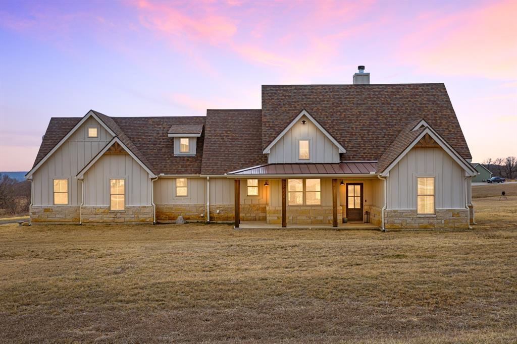 This builder-crafted home, completed in 2023, located on 2.01 acres in the Silver Lakes Ranch community, offers a modern ranch design with sophisticated elegance. Board-and-batten siding rests on a stone-accented base, with warm cedar beams framing the front porch. As you step inside, your eye is naturally drawn to the living room, the true focal point of the home. Anchored by a wood-burning fireplace and filled with natural light from two sets of white French doors, the space feels open yet intimate. The doors frame the backyard like living artwork, softly blurring the line between indoors and out. Morning light moves gently across the floors, while evenings settle comfortably around the fire. The kitchen is striking and functional, dressed in rich black granite that carries across the countertops and oversized island. A deep sink, stainless microwave, dishwasher, and electric oven pair with a thoughtful layout designed for everyday ease and effortless gathering. Black granite continues into the bathrooms for a cohesive finish. Straight from the garage, a mudroom connects to a half bath, storage closets, and laundry—keeping daily routines organized without disrupting the home’s flow. Three bedrooms are positioned on the main level for comfort and convenience. Upstairs, a private flex room with full bath and storage closet works beautifully as a fourth bedroom, office, or gym. The primary suite offers dual vanities · a glass-enclosed shower · a white freestanding tub ·and a spacious 12x7 walk-in closet. The covered 17x13 patio overlooks the full 2.01 acres and a tranquil pond in the distance. Residents of Silver Lakes enjoy private security · an on-site fire station · clubhouse · pool · and fitness center. Since construction was completed, the sellers have added an asphalt driveway · gutters · and established Bermuda grass, continuing the care invested from the start. This is more than a new home. It’s space to breathe, gather, and settle into something lasting.