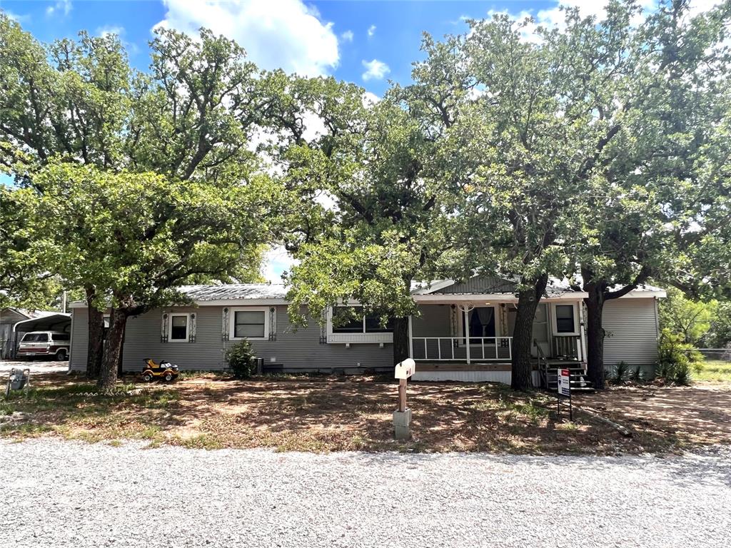 Here's a 1985 double wide that needs some work, but it has the potential to be a very nice property. It has three bedrooms and 2 bathrooms and an attached two car garage with newer doors. Lots of nice oak trees in the front and back yard. Plumbing has recently been replaced with Pex. Private location at the end of W 16th.  Detached Carport.  Huge tree covered fenced backyard.  Grab this one and finish it out in your own style!