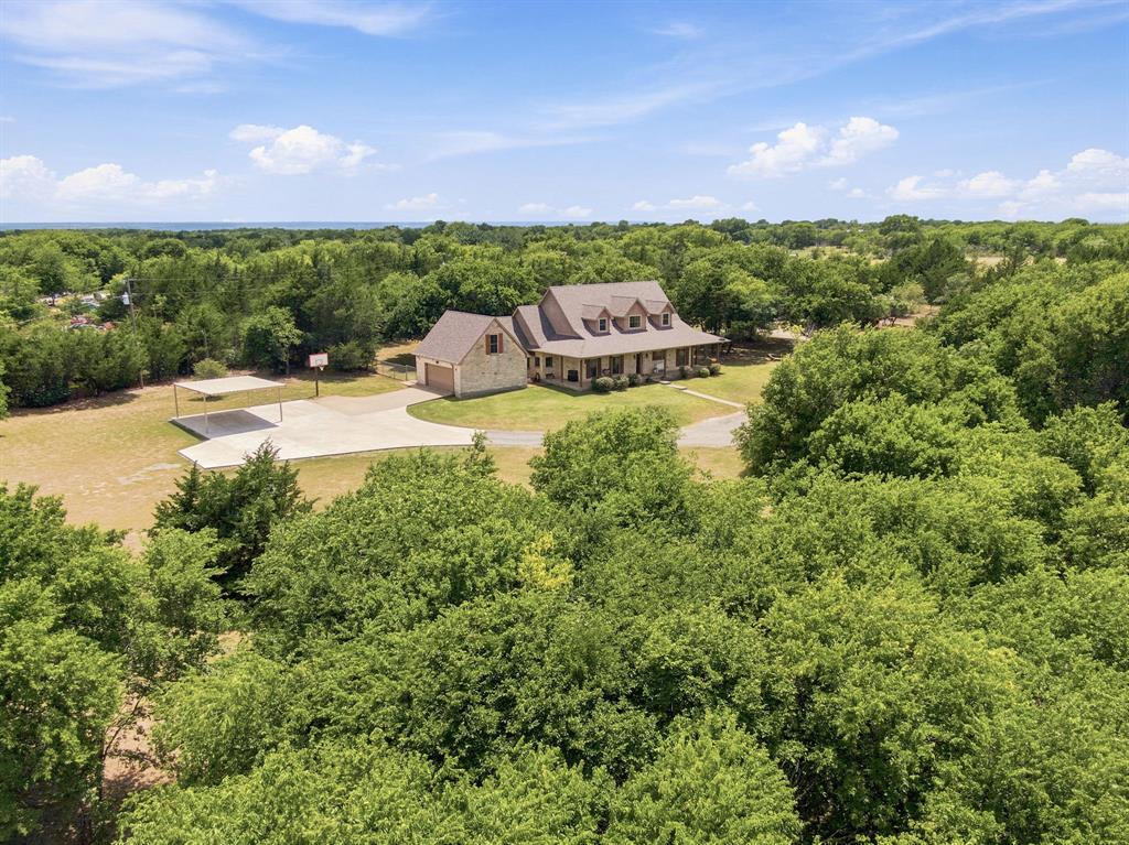 ****Open House SATURDAY JULY 11TH FROM 10 AM TO 1 PM***** Ranch Style Property in Waxahachie with Maypearl ISD! Welcome to this beautiful 2003 two-story home situated on just over 7 acres in Ellis County. Tucked away behind a beautiful tree line, this property offers privacy, space, and a peaceful setting while still being conveniently located.

The fully fenced acreage provides endless possibilities with a large shop, barn area, animal pens, and plenty of room for outdoor projects, equipment, or enjoying the land. The barn area also features a 700 sq ft guest home, offering additional living space, a private retreat, or flexible space for a variety of needs. A newer metal two-car carport provides additional covered parking. The Class 4 impact resistant roof was installed last year meaning you have years of a SOLID roof over your head! The new Pella brand windows were also installed last year!  

Inside the home, you’ll find a beautifully updated kitchen with modern finishes, ample storage, and a breakfast nook that creates the perfect space for everyday dining. The kitchen flows into the main living areas, where handscraped hardwood floors bring warmth and character throughout the living spaces and formal dining room.

The spacious floor plan offers the primary suite downstairs featuring an updated bathroom with a beautiful walk-in shower and separate his-and-her closets. Additional bedrooms are located upstairs, including two large secondary bedrooms, with another bedroom downstairs that provides flexibility for guests, an office, or additional living space.

Outside, the property continues to impress with the combination of acreage, a large shop, guest quarters, fenced land, and room to make it your own. Whether you’re looking for a ranch style property, space for animals, equipment, hobbies, or simply more room to spread out, this Waxahachie property in Maypearl ISD offers a rare opportunity.