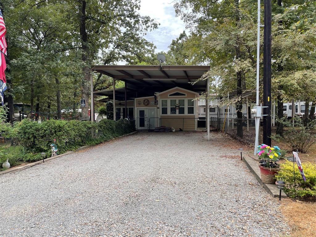 Located in the highly desirable community of White Oak Shores on the World Famous Lake Fork.  This property boasts 4 spacious adjoining lots.  There is a spacious park model that has a large 18x33 living room addition.  The park model features a cozy bedroom, full sized kitchen and a spacious bath with double shower.  On the adjacent lots there is an oversized metal cover that can fit multiple boats or an RV.  In addition there a 2 storage buildings.  There yard is so relaxing with the fire pit and garden and it is completely fenced with chain link.  White Oak Shores features a private boat ramp and dock, community facilities and a community pool for homeowners use.