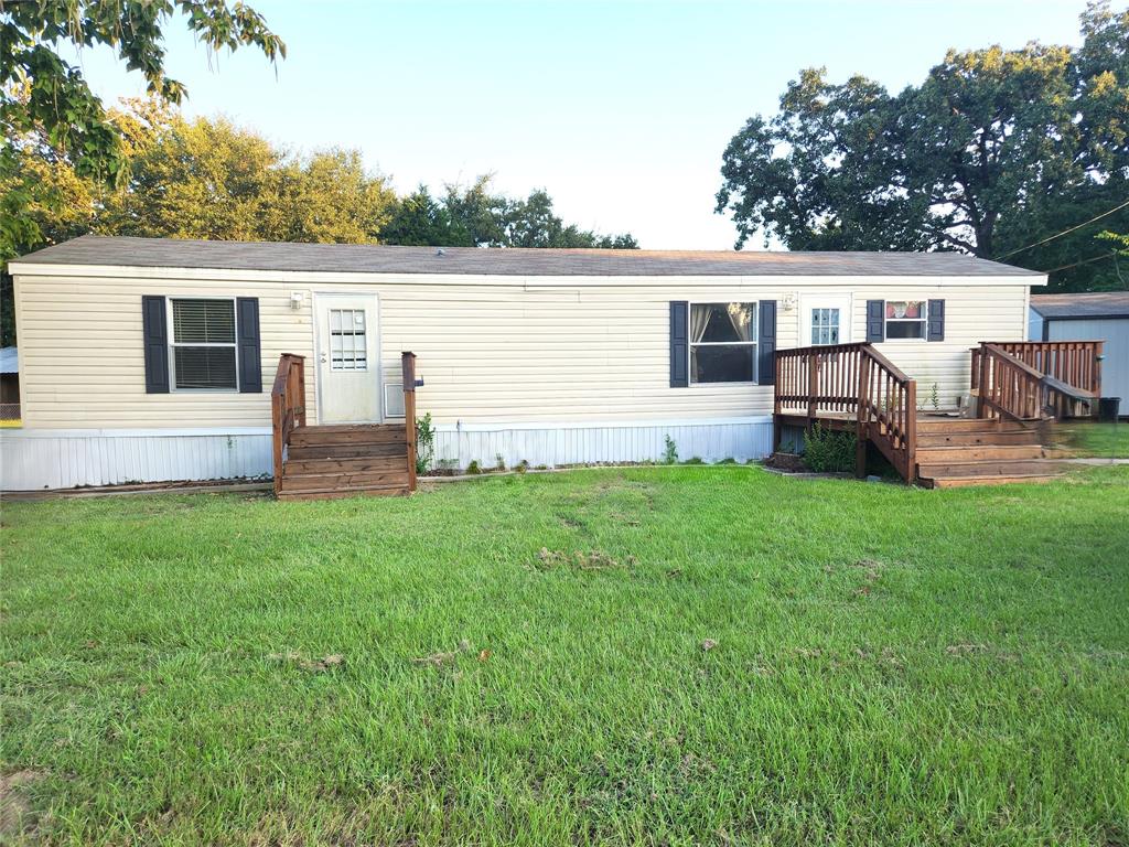 Neat as a pin and ready for its new owner. Very well-maintained home with open living and kitchen. Two bedrooms, full bath with shower and tub, stacked washer and dryer. Two car carport and a nice sized storage building, wood deck on the front. Large, landscaped yard with nice trees, established grass and is fenced on 3 sides. Plenty of room to park boats, RV, or other vehicles in the front or in the back. This is a quiet, waterfront neighborhood and is only minutes away from shopping and restaurants. Come enjoy boating, fishing and other water activities on beautiful Cedar Creek Lake.