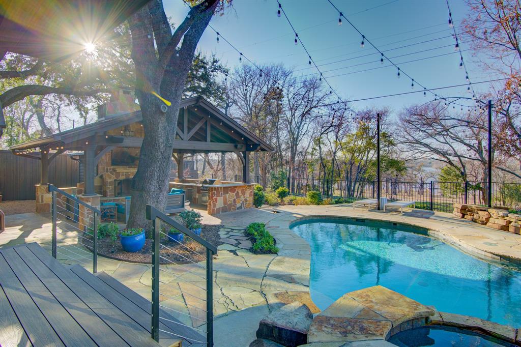 This Hill Country Home in the heart of the Peninsula Neighborhood of East Dallas MUST be seen to believe! With remarkable architectural design and extraordinary finishes by top designers, pictures simply cannot capture the Absolute Beauty of this Incredible Property! Designed to blend Top of the Line Luxury with Breathtaking Views of White Rock Lake, this home offers a seamless balance of Elegance and a Warmth that draws you in. The open-concept layout features Soaring Ceilings, abundant natural light, and magnificent finishes, including the highest level stone and tile-work from Ann Sacks, Custom Hardware throughout and Exquisite Moroccan Lanterns inside and out. The gourmet kitchen is a chef’s dream, with a Thermador Appliance Package, Built-in Refrigerator, BlueStar Custom Pro Range & Hood, a Huge Island and a fully loaded Butlers Pantry, making it ideal for hosting gatherings large or small. The Sumptuous Primary Suite is a true Sanctuary, boasting Expansive Windows with Sweeping Views of WRL, the Marinas, Downtown Dallas and the most Amazing Sunsets in DFW! Across the home you will find spacious secondary bedrooms that capitalize on the incredible views from every window with one oversized Mother-in law suite with it's own kitchen and ensuite bath! The Backyard is a feast for the eyes with views from every angle, a Gorgeous Saltwater Pool and Jacuzzi Spa and a Fantastic Oversized Cabana with outdoor kitchen, Fireplace, Ice Maker, Fridge and more. This entire property is connected with high-end technology through an Aegis AV Home System allowing you to control ALL aspects of the home from one place and on your phone! Do not wait another minute to experience this home where extraordinary views and exceptional design come together to create a lifestyle like no other!